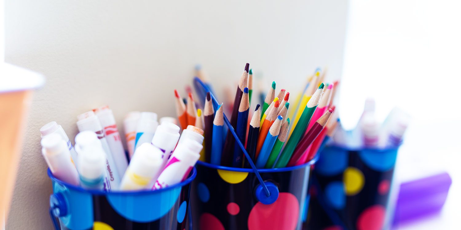 Art supplies in bright containers.