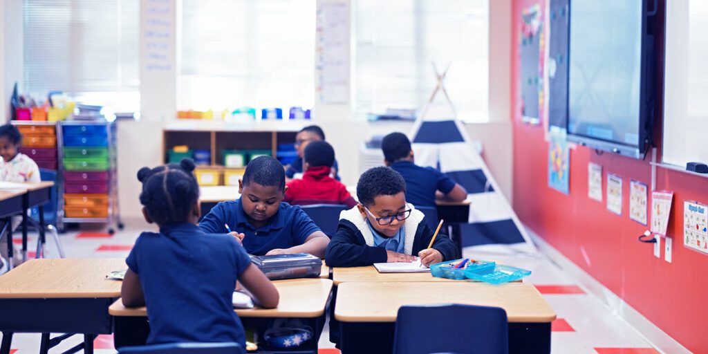 Students doing a writing assignment in a classroom.