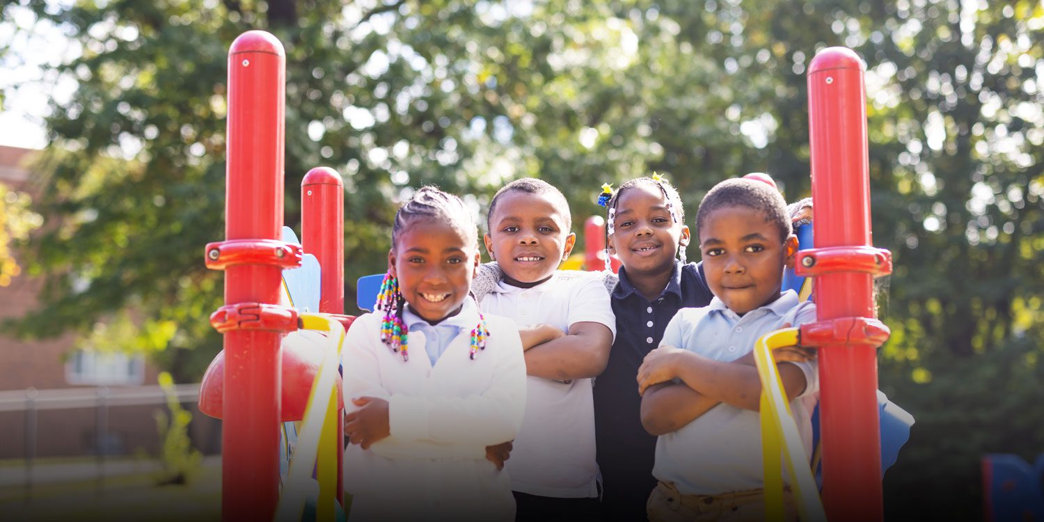 Group of students at the playground with their arms crossed