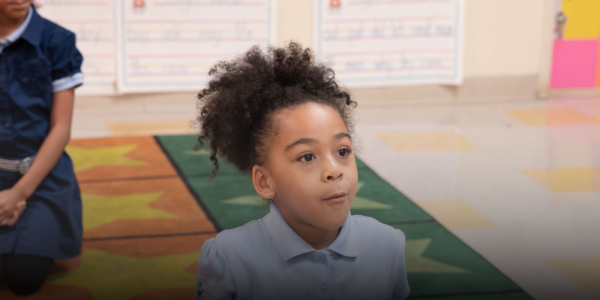 Student sitting on rug