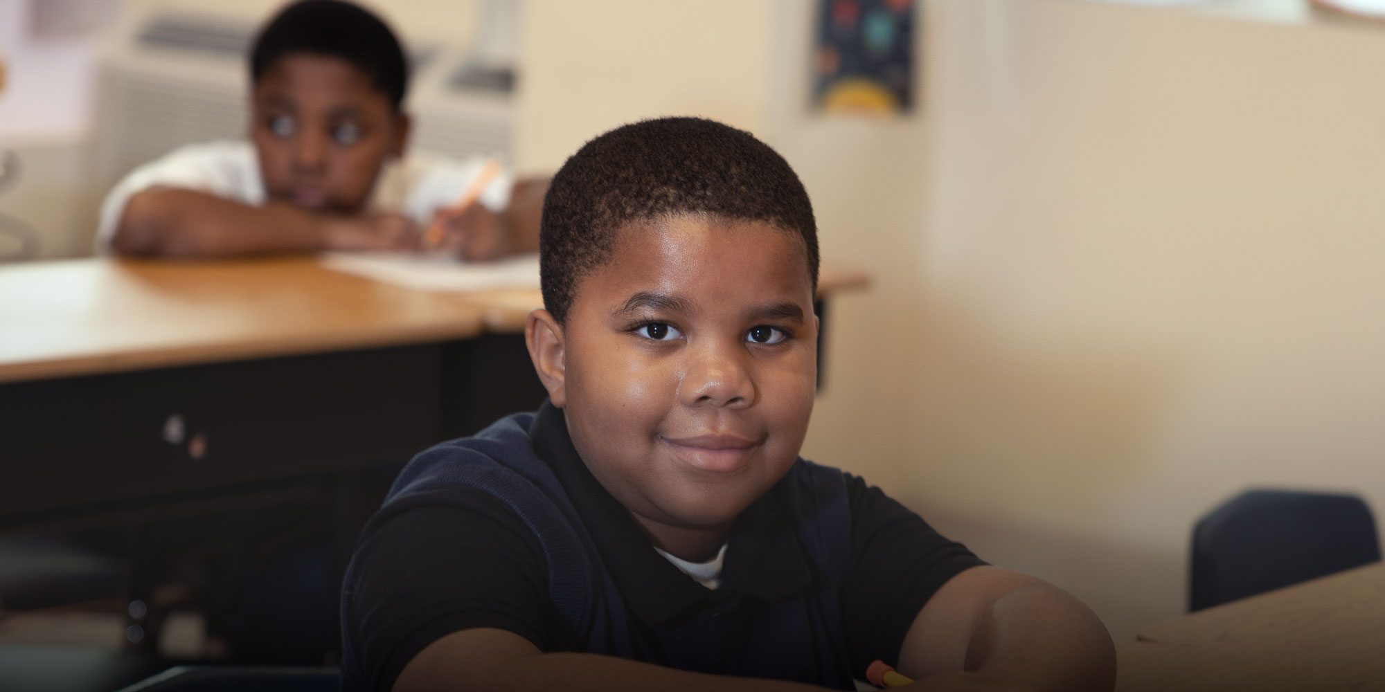 Smiling student working at desk