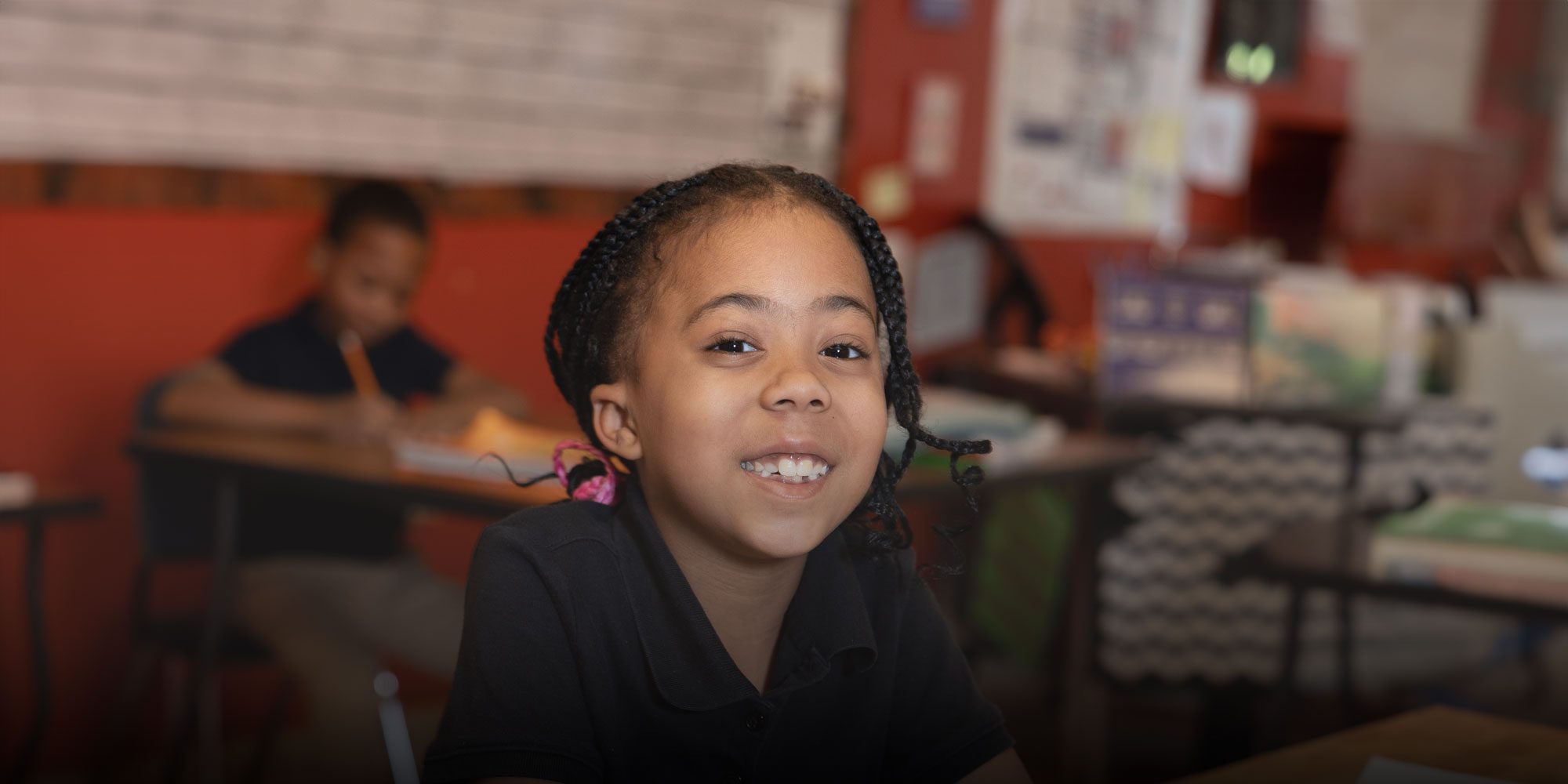 Smiling elementary student working at desk