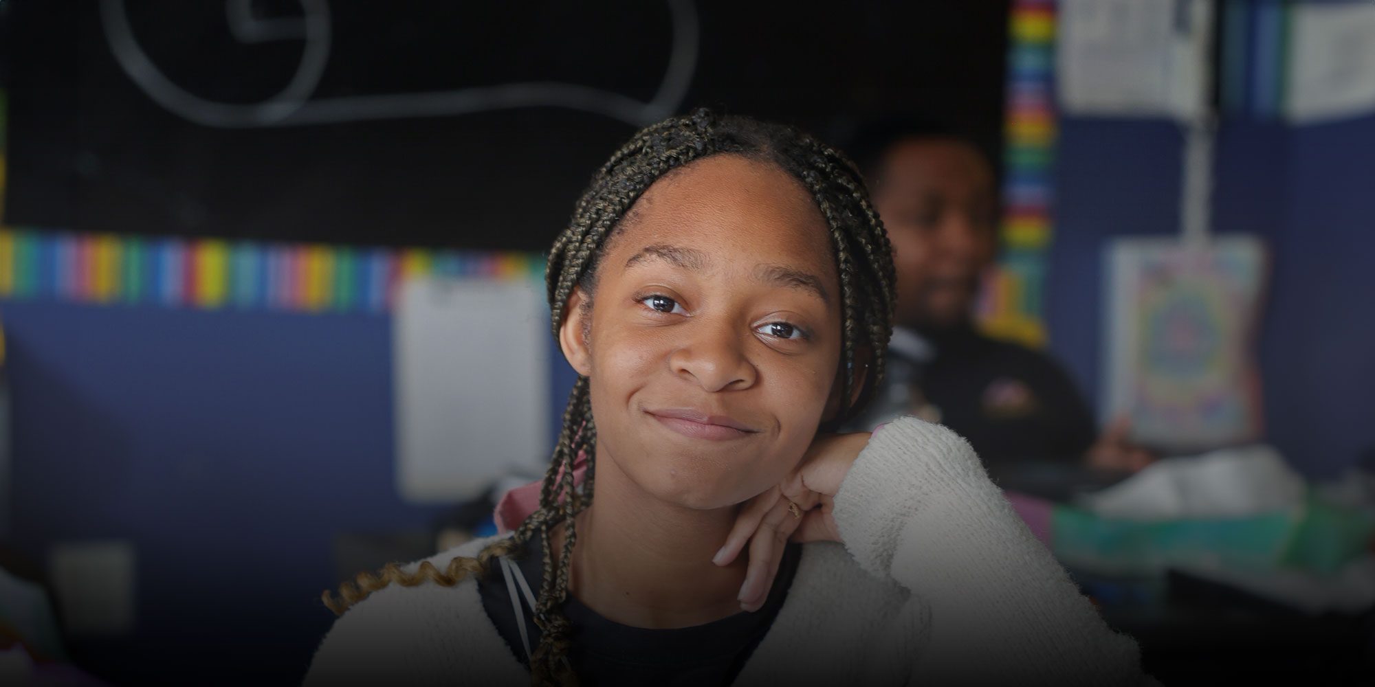 Smiling student sitting at desk